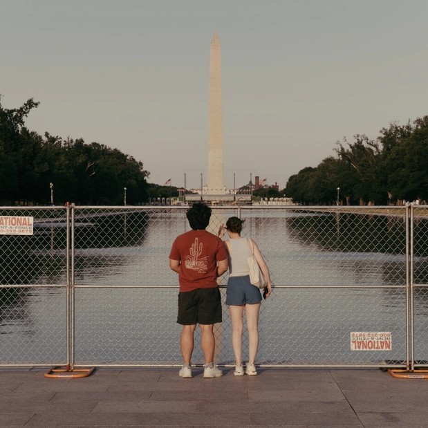 Caroline Gutman Two visitors look through temporary fencing on June 25. - The Atlantic Politics